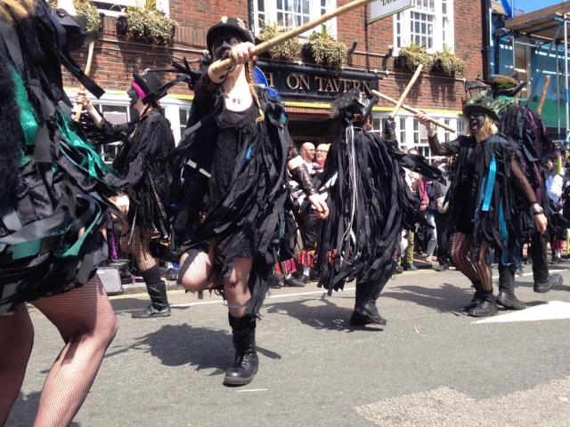 Border morris dancers with black rags and sticks
