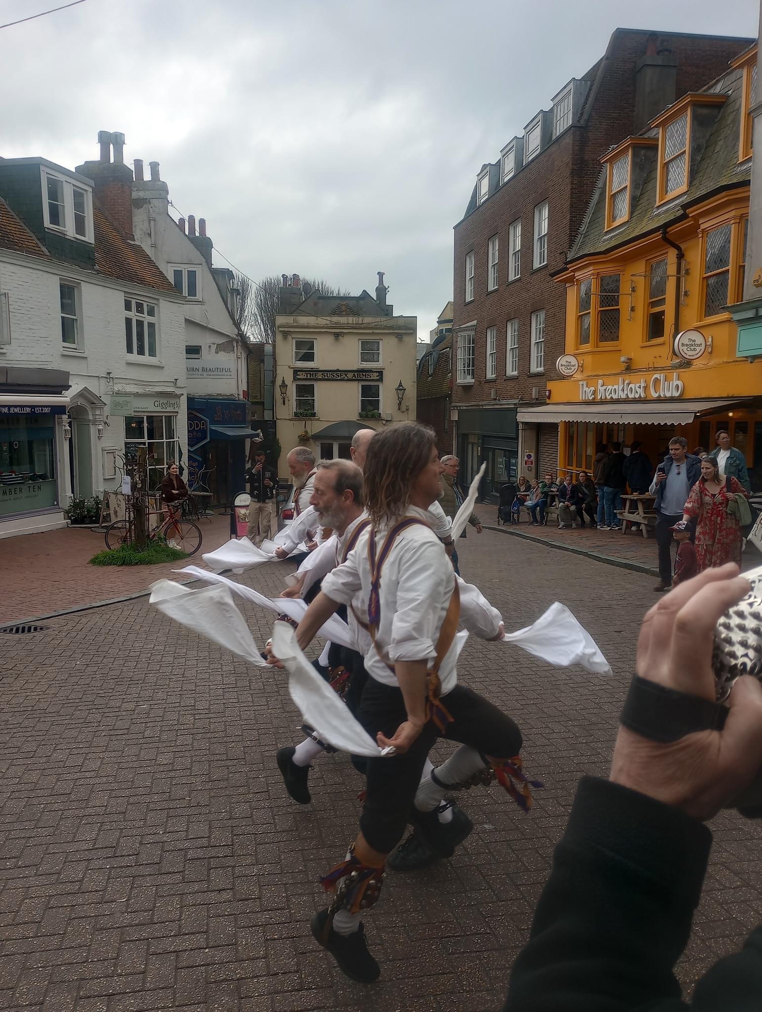 Brighton Morris dance in a single straight line outside The Pump House pub in Brighton on May Day